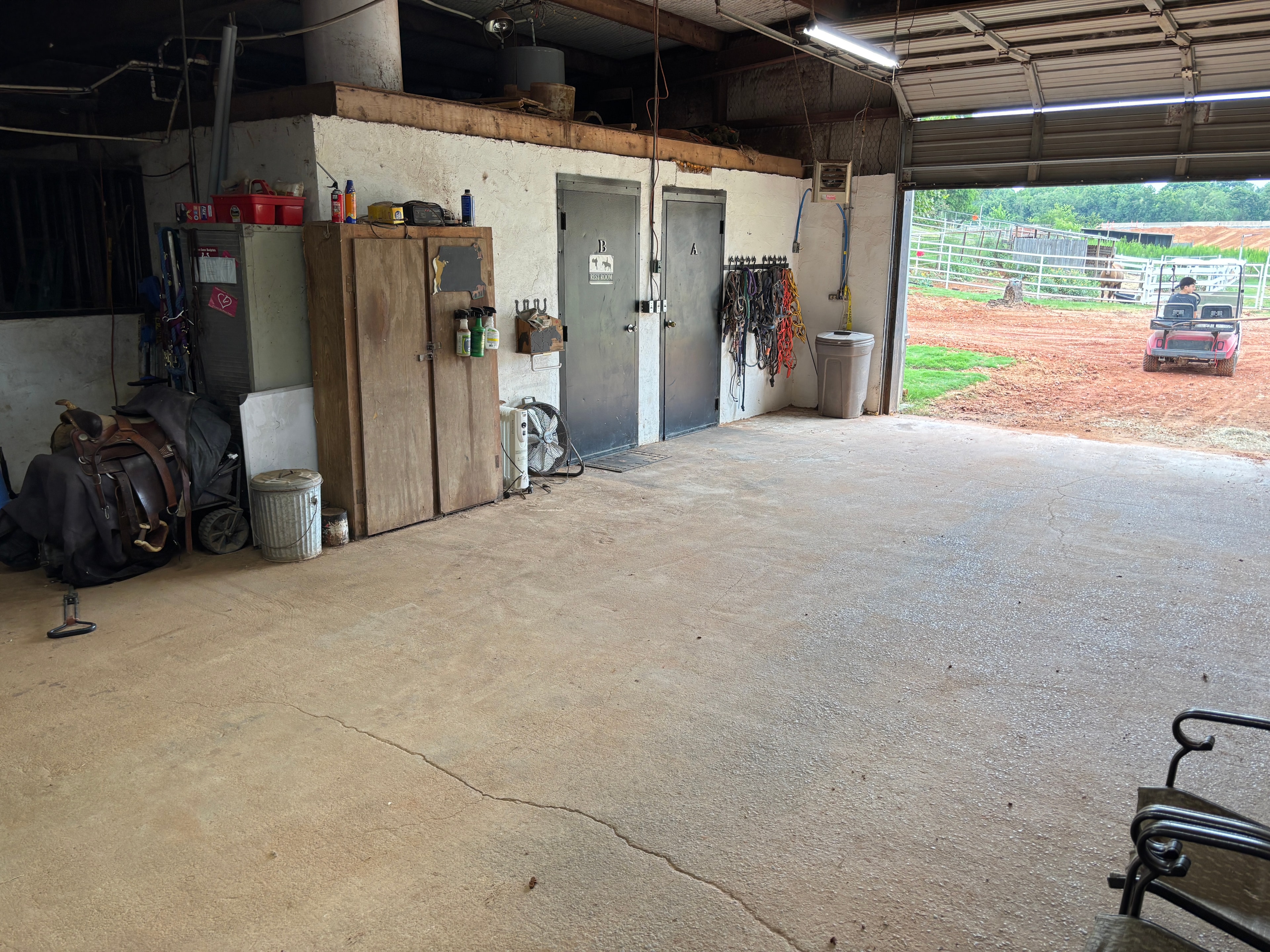 Barn interior with tack room doors and equipment