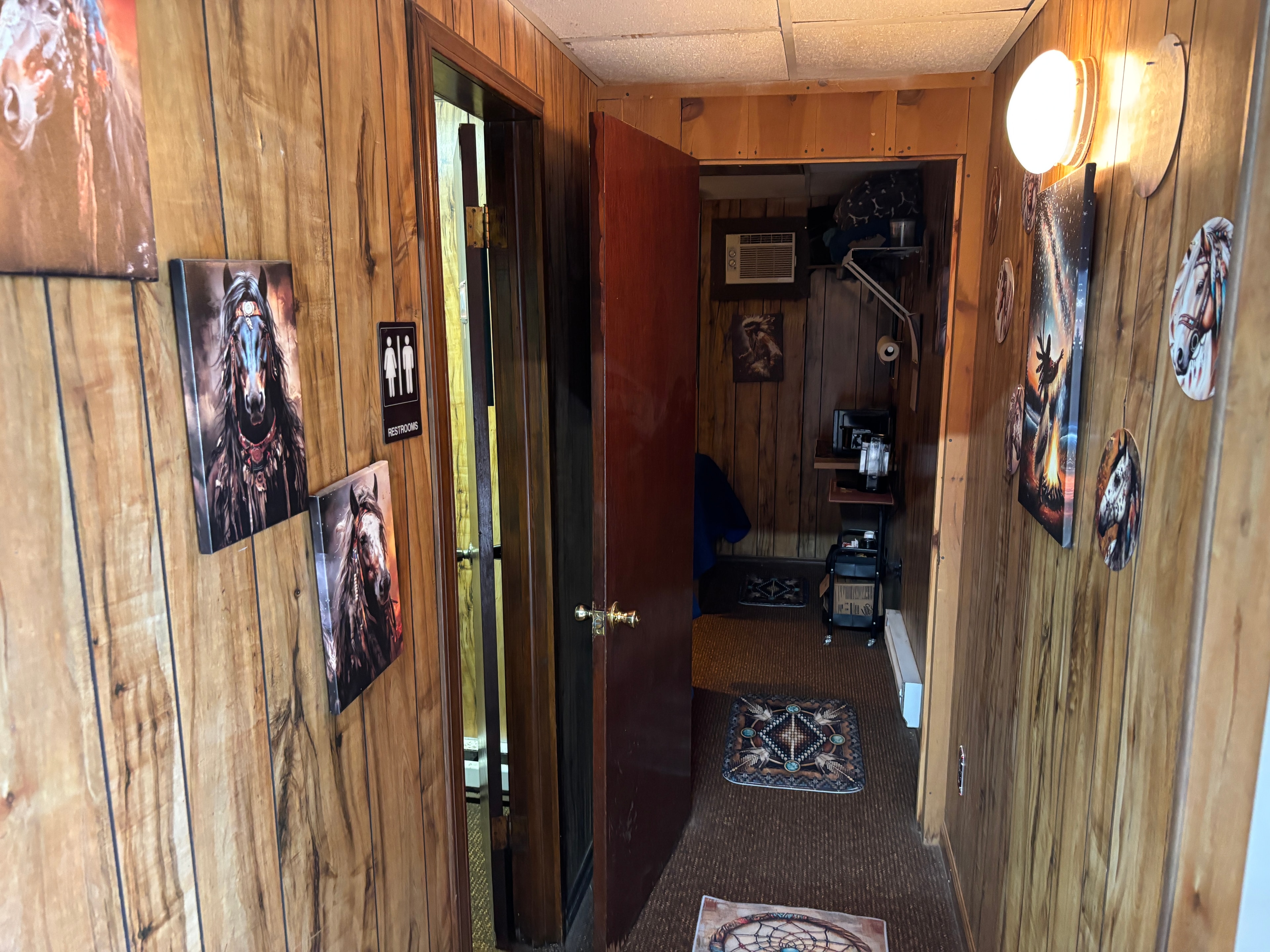 Rustic guest bathroom with wood paneling and western décor