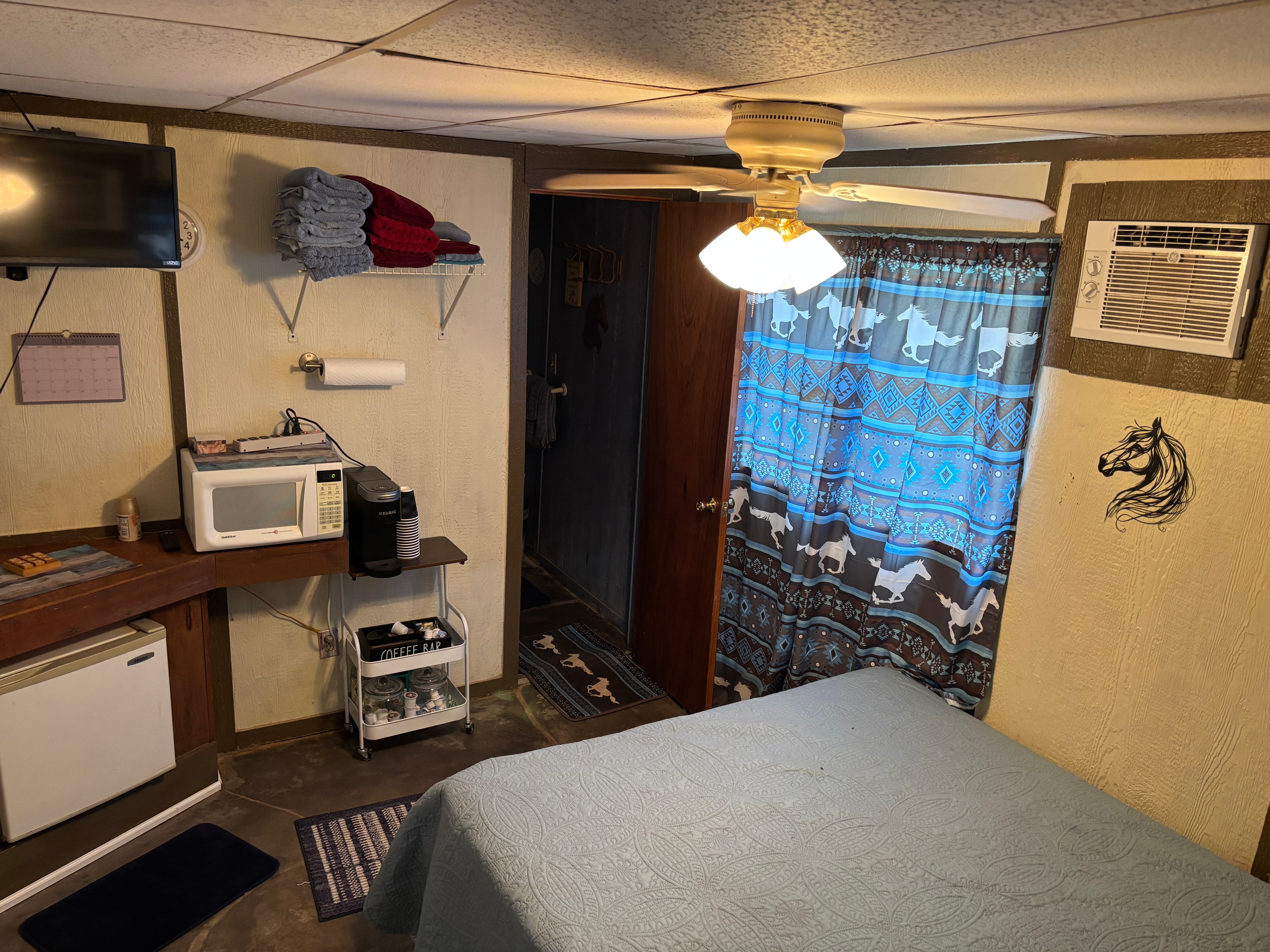 Overnight guest room with bed, TV, and coffee bar