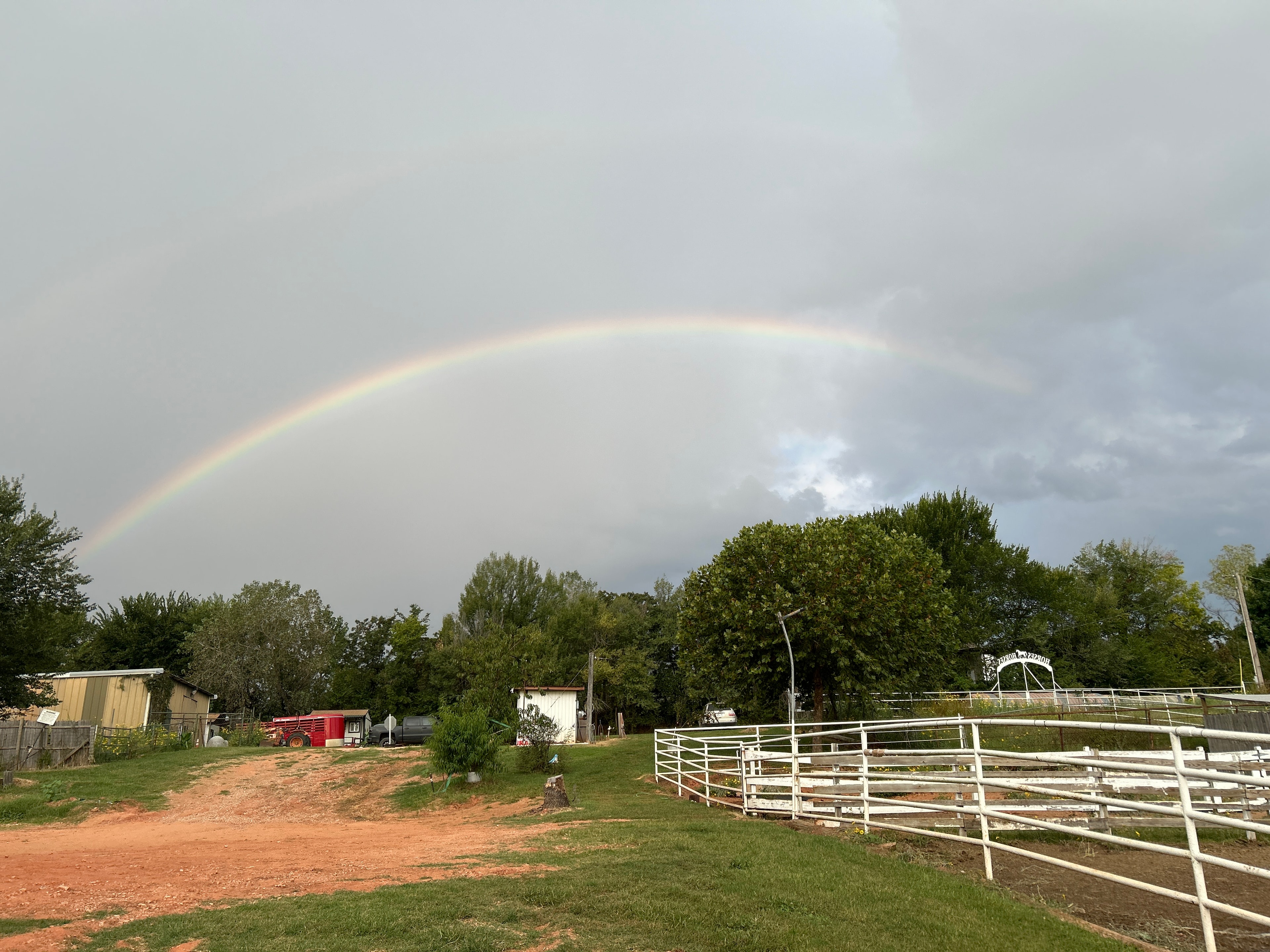 Ranch paddock with white fencing and open pasture